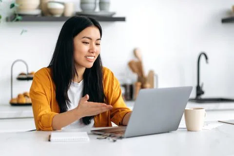 Distant communication. Friendly pretty asian brunette girl, manager, freelancer Stock Photos