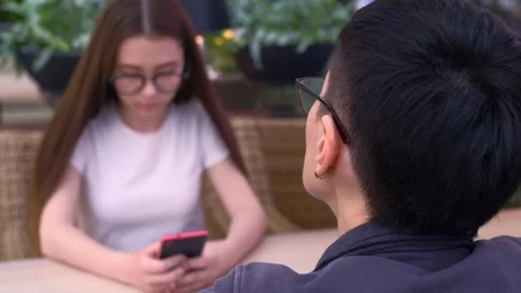 Distant Connectivity: Friends at Bar with Smartphone Dilemma Stock Footage 260486156