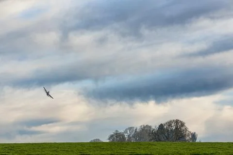 Distant Crop-duster under cloudy skies Stock Photos