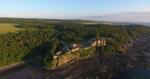 Distant Drone Shot with a Green Scottish Forest and an Old Castle Stock-Footage 97380491
