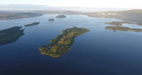 Distant Drone Shot of Scottish Loch with Green Islands and Landscape 스톡 동영상 97571746