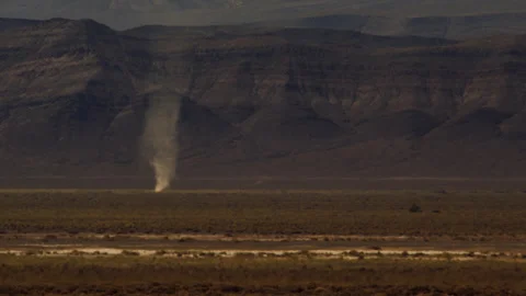 Distant dust devil rips through the shimmering desert heat of summer. Stock Footage 270498892