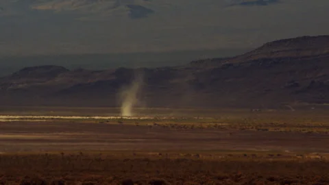 Distant dust devil rips through the desert on a scorching summer’s day. Stock Footage 270499501
