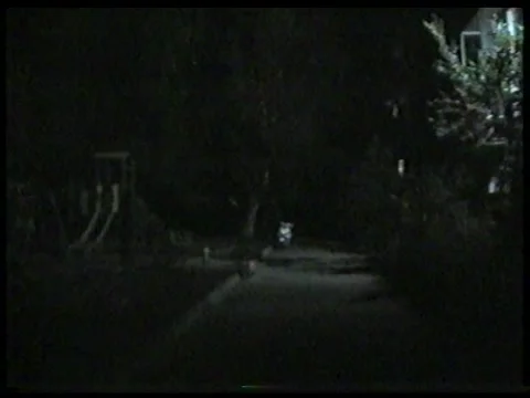 Distant Empty Playground at Night Beneath an Apartment Streetlight Vídeo Stock 344996152