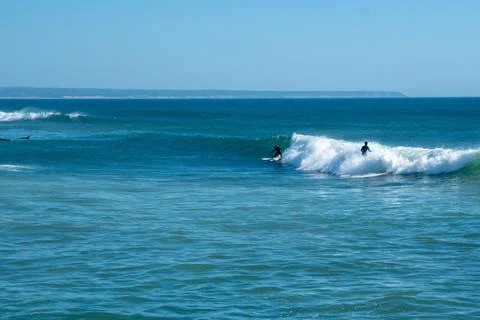 A Distant Figure Conquering the Waves Foto stock
