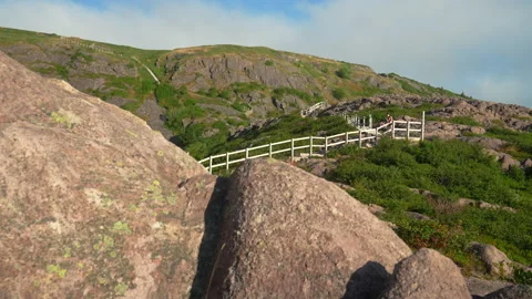 Distant figures descend steps on North Head Trail Stock Footage 214497306