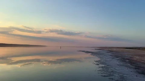 Distant Figures Standing On Shallow Water At Dusk Stock Footage 341755920