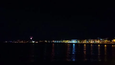 Distant Fireworks Exploding Over Night Coastal Cityscape Vídeos de archivo 337203373