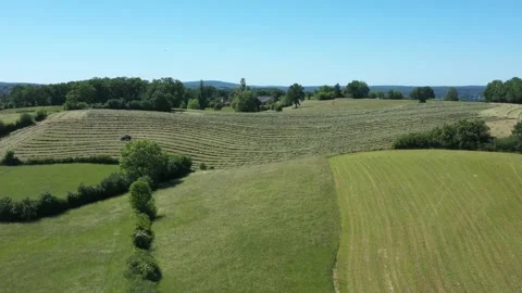Distant forward tracking shot on a tractor doing round balls Stock Footage 144541568
