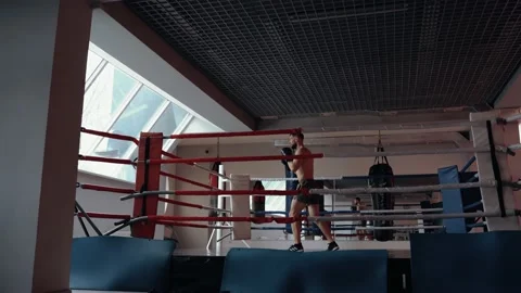 A distant frame of a handsome young man, a fighter who trains on the battlefield Stock Footage 156851284