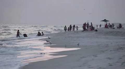 Distant Group of People Playing On The Beach at Sunset Stock Footage 53228388