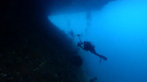 Distant group of scuba divers swimming in overhang in Indonesia, HD, UP23819 Stock Footage 38307381