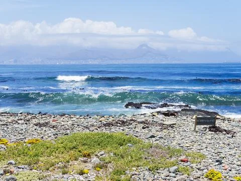 A distant hazy, cloud covered Cape Town as seen from Robben Island Stock Photos