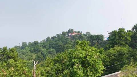 Distant Hilltop Temple Surrounded by Lush Green Forest Landscape View Stockbeeldmateriaal 347763120