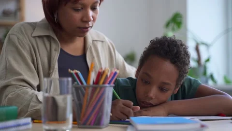 Distant home schooling of junior children mother with son spbd Stock Footage 166018796