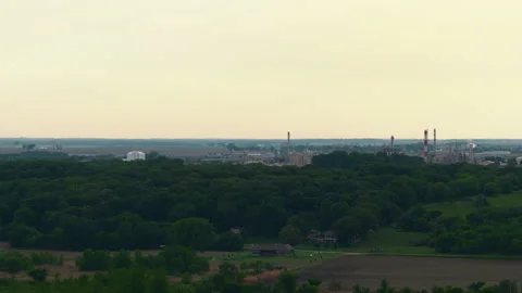 Distant Industrial Plant Beyond Forest and Farmland on Iowa Horizon Stock Footage 337615694