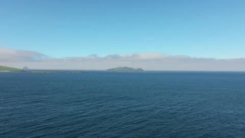 Distant Island Amidst Expansive Blue Sea Under Clear Sky Vídeos de archivo 337037063