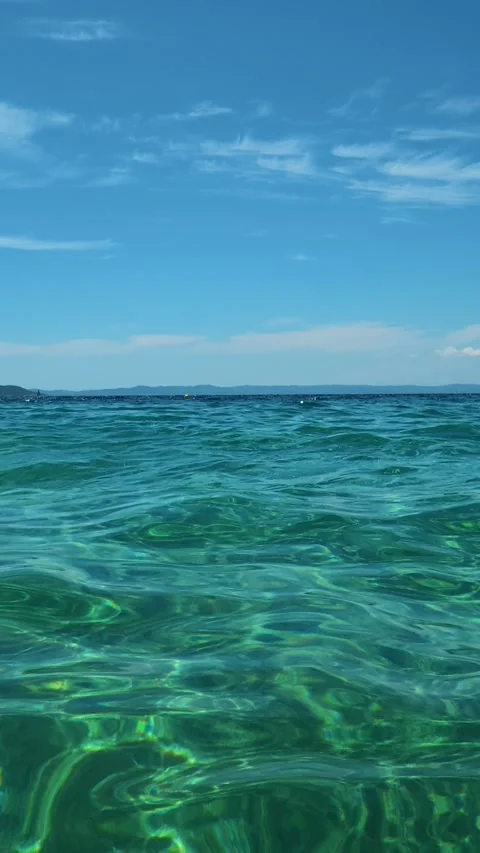 Distant island barely visible on horizon's edge. Lagomandra, Greece. Vertical Stock Footage 339627326