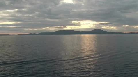 A distant island at sunset, over the ocean Stock Footage 11193509