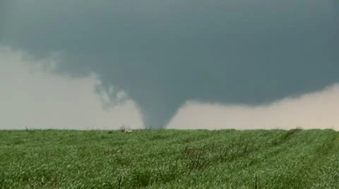 Distant, large violent tornado over farmland in Texas. High quality. Tripod. Video stock 11435819