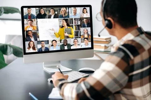 Distant learning, online education. View over a guy's shoulder, a computer Fotos de archivo