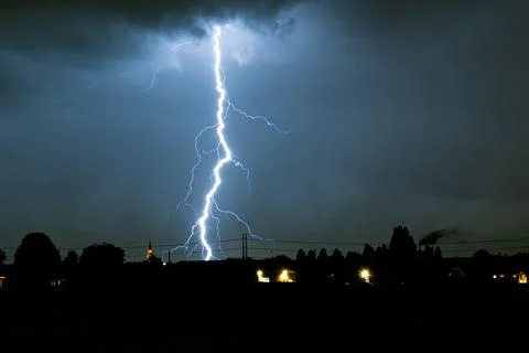 Distant lightning bolt strikes down from a storm Stock Photos