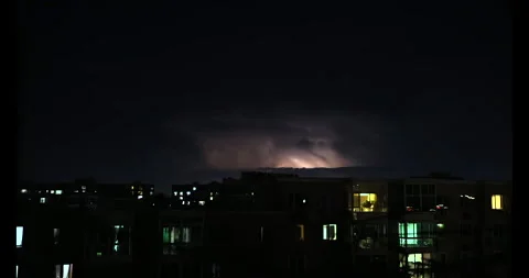 A distant lightning at night in the middle of City Stock Footage 295010017