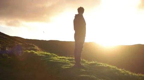 Distant look at man staring into the Sunset Stock Footage 59188726