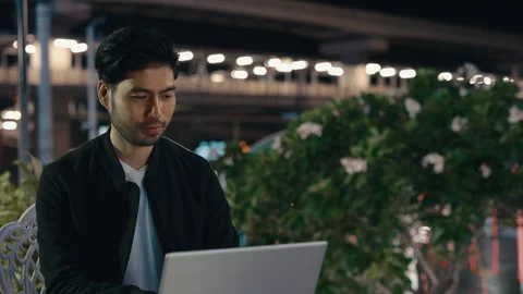 Distant manager using portable computer for online chat sitting near evening Stock Footage 309548406