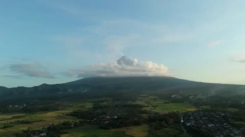 Distant Mayon Volcano looms under soft sky. Cinematic Landscape Vídeos de archivo 333521569