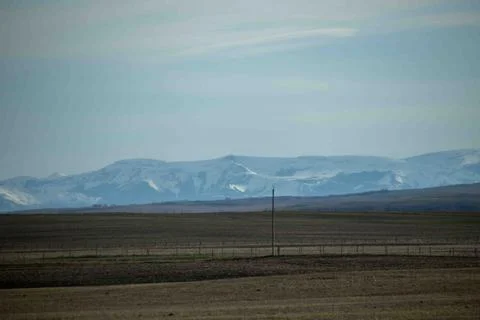 A Distant mountain and the prairies Stock Photos