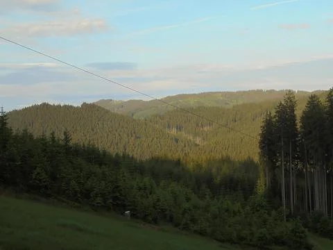 Distant mountain landscape covered in evening sunlight. Panoramic Beskydy image. Foto stock
