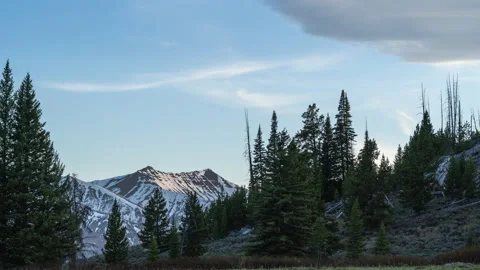 Distant mountain peak framed by trees at sunset 스톡 동영상 167116276