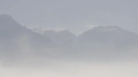 Distant mountain range with a lot of haze high wind Stock Footage 310532313