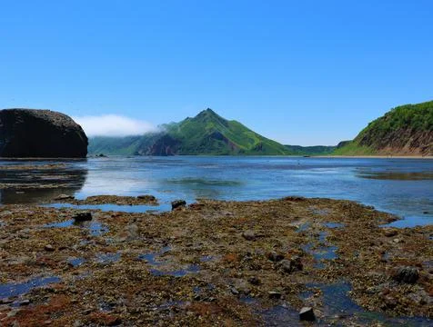 Distant mountain view in Bukhta Tikhaya on Sakhalin Island, beautiful landsca Stock Photos
