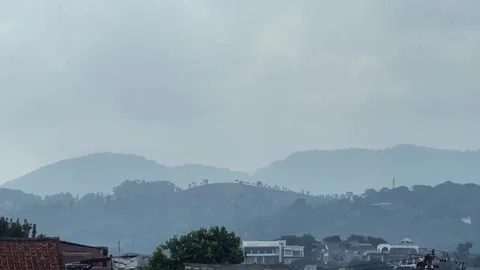 Distant mountains and hills landscape under a hazy overcast sky Video stock 341897061