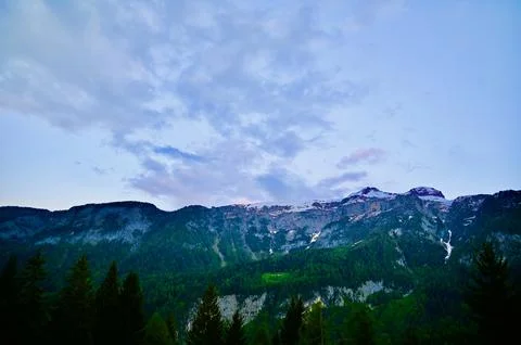 Distant Mountains Under a Cloudy Twilight Sky Stock Photos
