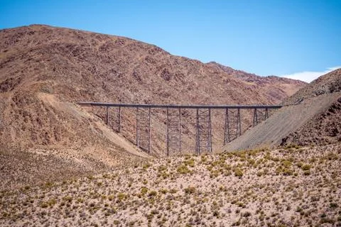 Distant panoramic view of an old and rusty railroad bridge. Stock Photos