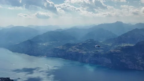 Distant Paraglider Gliding Across Lake Garda Mountain Landscape Stock Footage 340775005