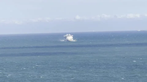 Distant passenger ferry navigating sea 4K Stock Footage 336510173