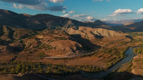 Distant passenger train moves along a riverbank (Dogu Ekspresi) Видео 338200103