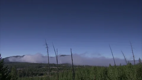Distant Perspective of Smoke Hanging Over Yellowstone Stock Footage 86755843