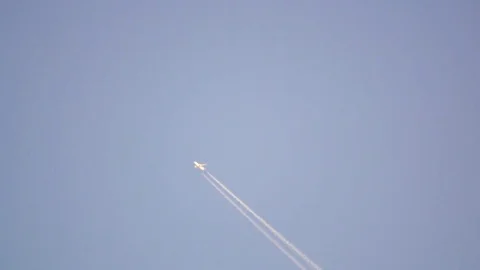 Distant Plain Leaving a Contrail in the Sky Stock Footage 75062732