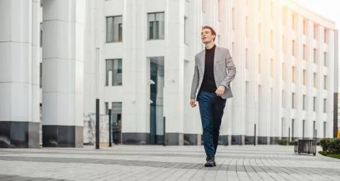 Distant plan of happy man going to or from work and dancing. Stock Photos