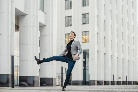 Distant plan of happy man going to or from work and dancing. Stock Photos