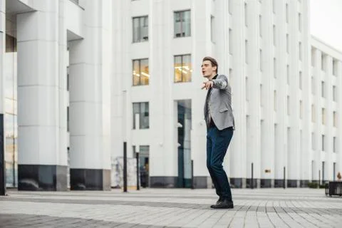 Distant plan of happy man going to or from work and dancing. Stock Photos