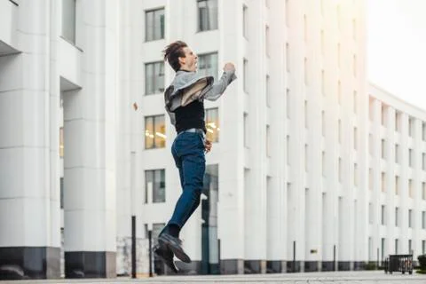 Distant plan of happy man going to or from work and dancing. Stock Photos