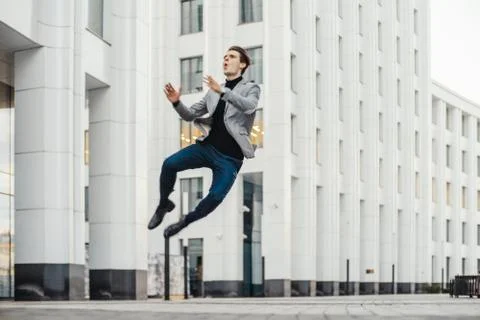 Distant plan of happy man going to or from work and dancing. Stock-Fotos