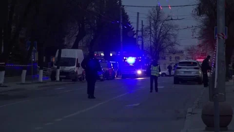 Distant police presence on empty closed road with flashing lights at night Stock Footage 332619484