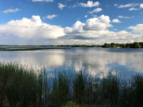 Distant Rain and Clouds Reflected in Minnesota Lake Stock Photos